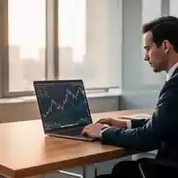 Ein Finanzanalyst arbeitet an einem Laptop in einem modernen, hellen Büro während der Dividendensaison. - Foto: über boerse-global.de