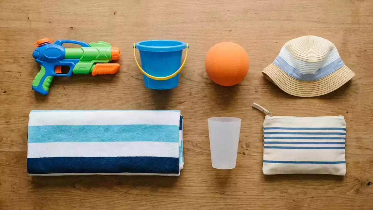 Flatlay-Arrangement rund um Wasserpistole mit passenden Requisiten von oben, neutral