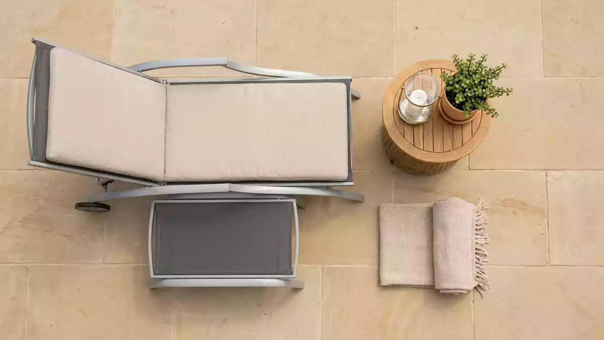 Flatlay-Arrangement rund um Gartenliege mit passenden Requisiten von oben, neutral