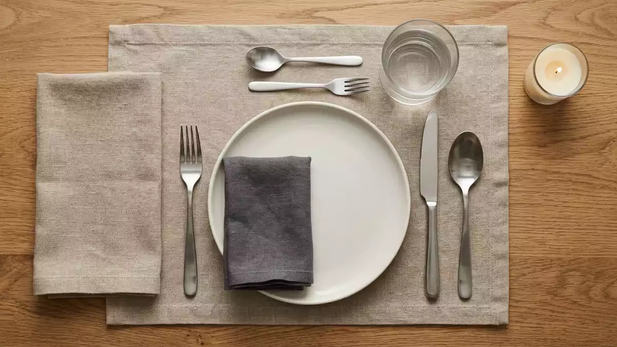 Flatlay-Arrangement rund um Besteckset mit passenden Requisiten von oben, neutral