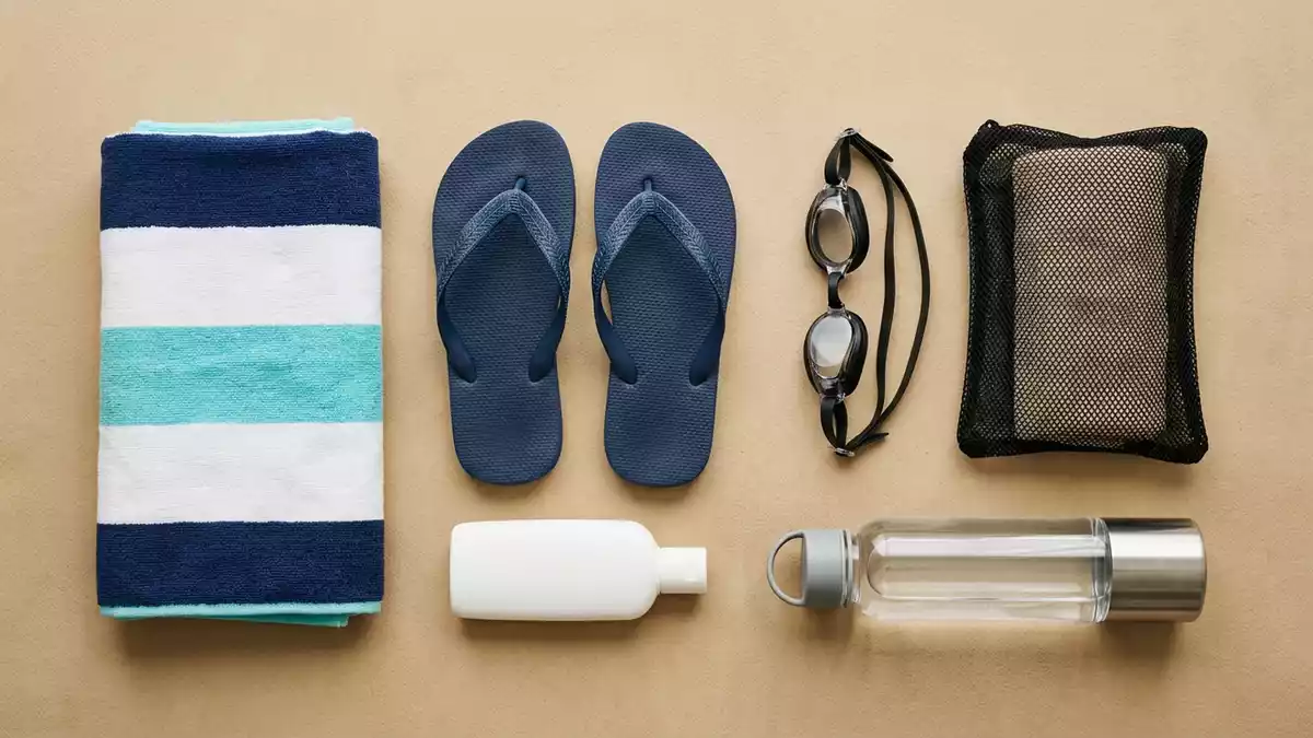 Flatlay-Arrangement rund um Badeschlappen mit passenden Requisiten von oben, neutral