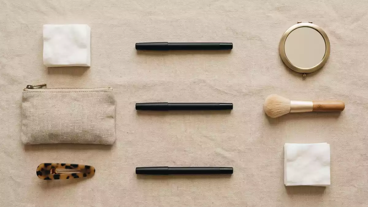 Flatlay-Arrangement rund um Augenstift mit passenden Requisiten von oben, neutral