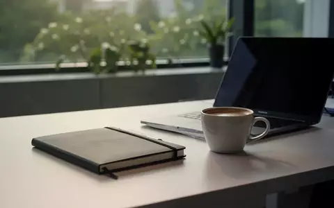 Ein aufgeräumter Schreibtisch mit einem Notizbuch und einer Kaffeetasse in einem hellen Büro am Morgen. - Foto: über boerse-global.de