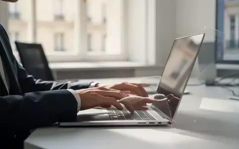 Eine Person arbeitet an einem Laptop in einem modernen, hellen Büro in Europa. - Foto: über boerse-global.de