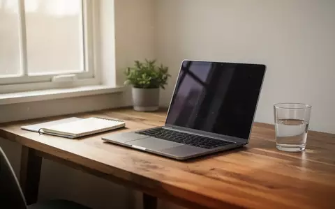 Ein aufgeräumter Schreibtisch mit einem Laptop und Notizbuch im sanften Morgenlicht als Symbol für den strukturierten Alltag. - Foto: über boerse-global.de
