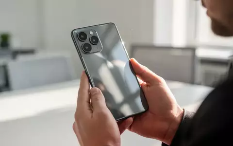 Nahaufnahme eines modernen Smartphones in einer hellen Büroumgebung, das die hochwertige Verarbeitung und das Glas-Design zeigt. - Foto: über boerse-global.de