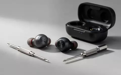 Hochwertige kabellose In-Ear-Kopfhörer liegen neben einem kleinen Präzisionsschraubendreher und einem Ladecase auf einem Tisch. - Foto: über boerse-global.de