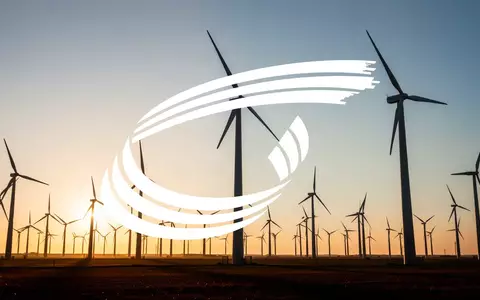Moderne Windkraftanlagen in einer weiten Landschaft während der goldenen Stunde als Symbol für nachhaltiges Energiewachstum. - Foto: über boerse-global.de