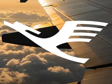 Flugzeugtragfläche über einer Wolkendecke bei Sonnenuntergang als Symbol für den Luftverkehrssektor. - Foto: über boerse-global.de