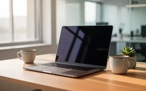 Ein moderner, minimalistischer Arbeitsplatz mit einem Laptop auf einem Holztisch bei natürlichem Tageslicht. - Foto: über boerse-global.de