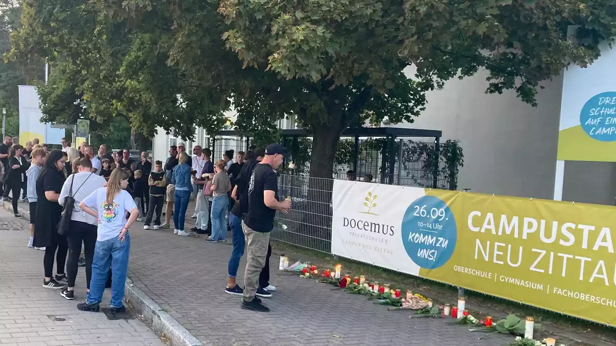 Menschen gedenken der zwei Toten in Neu Zittau.  - Bild: Wilhelm Pischke/dpa