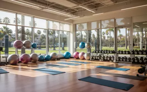 Ein heller, moderner Sportraum in einem Gemeindezentrum in San Diego mit Yogamatten und Fitnessgeräten vor großen Fenstern. - Foto: über boerse-global.de