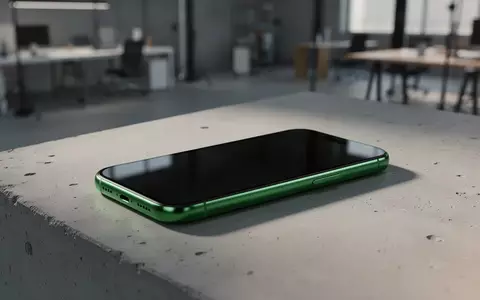 Ein modernes, grünes Smartphone liegt auf einer minimalistischen Betonoberfläche in einem hellen, professionellen Umfeld. - Foto: über boerse-global.de