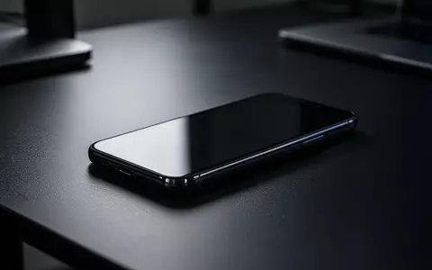 Ein modernes Smartphone liegt auf einem dunklen Büroschreibtisch in gedimmtem, stimmungsvollem Licht. - Foto: über boerse-global.de