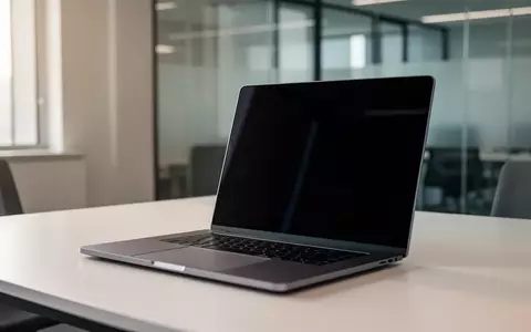 Ein minimalistischer Arbeitsplatz mit einem Laptop, dessen Bildschirm dunkel und unbeschriftet ist, in einem modernen Büro. - Foto: über boerse-global.de
