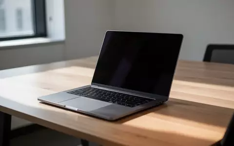 Ein minimalistischer Büroarbeitsplatz mit einem Laptop auf einem Holztisch bei natürlichem Tageslicht. - Foto: über boerse-global.de