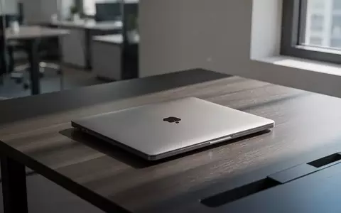 Ein geschlossener Laptop auf einem dunklen Schreibtisch in einem modernen Büro bei natürlichem Licht. - Foto: über boerse-global.de