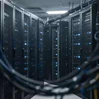 Dunkler Serverraum mit modernen IT-Schranksystemen und blauen Statusleuchten. - Foto: über boerse-global.de