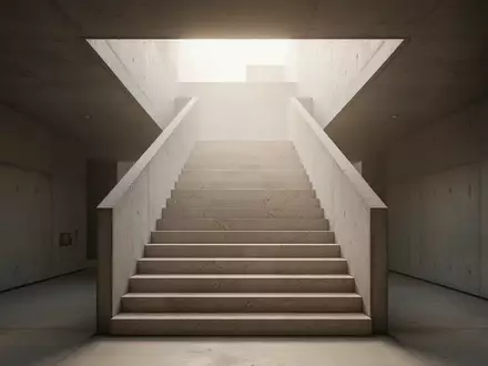 Eine minimalistische Steintreppe führt in einem modernen Gebäude nach oben in helles, diffuses Tageslicht. - Foto: über boerse-global.de