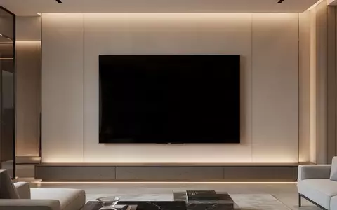 Ein moderner, minimalistischer Wohnraum mit einem großen, ausgeschalteten Flachbildfernseher an der Wand. - Foto: über boerse-global.de