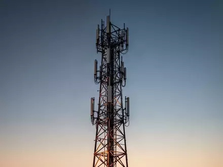 Ein moderner Sendemast für Telekommunikation steht vor einem klaren Abendhimmel als Symbol für digitale Warninfrastruktur. - Foto: über boerse-global.de
