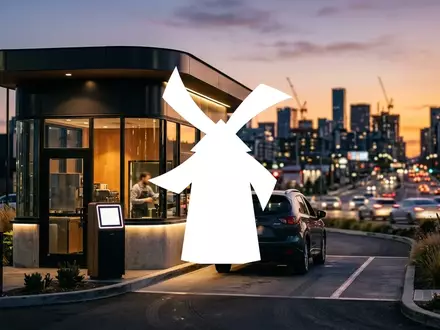 Moderne Drive-in-Kaffeebar vor einem verschwommenen urbanen Hintergrund bei Sonnenuntergang. - Foto: über boerse-global.de