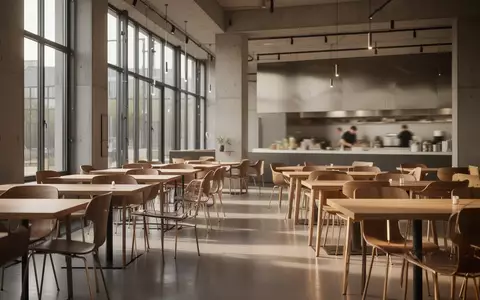 Modernes, minimalistisch gestaltetes Restaurant-Interieur mit großen Fenstern und geordneten Sitzbereichen. - Foto: über boerse-global.de