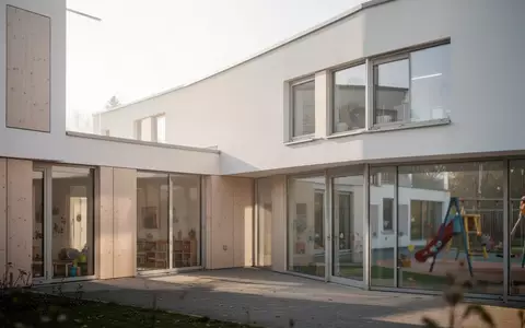 Modernes Kindertagesstättengebäude in einer ruhigen Umgebung bei Tageslicht - Foto: über boerse-global.de