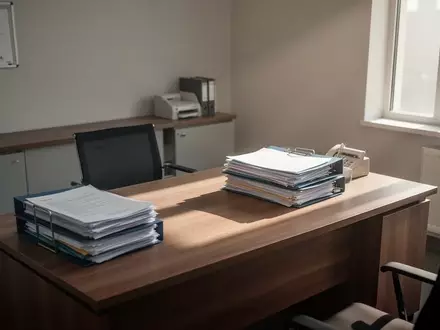 Leeres Büro mit Aktenordnern auf einem Schreibtisch, das die angespannte finanzielle Lage in der Pflege symbolisiert. - Foto: über boerse-global.de