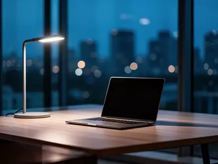 Ein leerer, minimalistischer Schreibtisch in einem modernen Büro bei Dämmerung mit einem geschlossenen Laptop. - Foto: über boerse-global.de