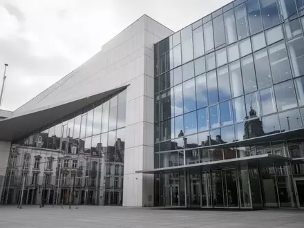 Ein modernes, minimalistisches Behördengebäude in Brüssel mit einer Glasfassade, die den Himmel reflektiert. - Foto: über boerse-global.de