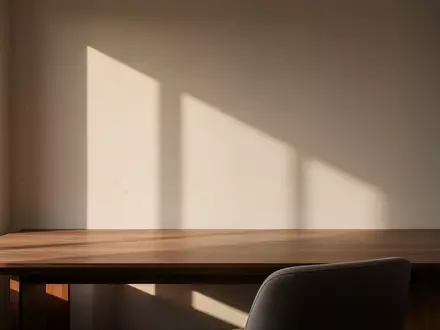 Ein minimalistischer, moderner Arbeitsplatz mit einem leeren Holztisch in hellem Morgenlicht. - Foto: über boerse-global.de