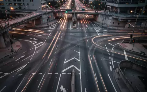 Eine leere urbane Straßenkreuzung bei Dämmerung mit komplexen Fahrbahnmarkierungen und städtischer Infrastruktur. - Foto: über boerse-global.de