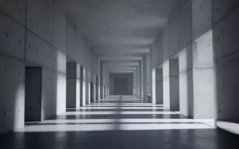 Ein leerer, minimalistischer Flur in einem Regierungsgebäude mit klaren Betonwänden und architektonischen Schattenwürfen. - Foto: über boerse-global.de