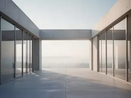Minimalistische moderne Architektur mit klaren geometrischen Linien und hellen Betonflächen unter einem klaren Himmel. - Foto: über boerse-global.de