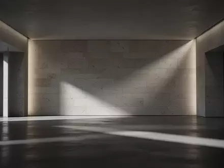 Eine leere, von dramatischem Licht beleuchtete Steinwand in einem modernen, minimalistischen Innenraum. - Foto: über boerse-global.de