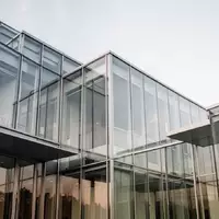 Moderne Architektur aus Glas und Stahl bei Tageslicht, die die Stabilität und Transparenz im Finanzsektor symbolisiert. - Foto: über boerse-global.de