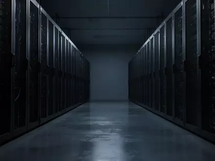 Dunkler Serverraum mit Reihen von industriellen Server-Racks in einer minimalistischen Umgebung. - Foto: über boerse-global.de
