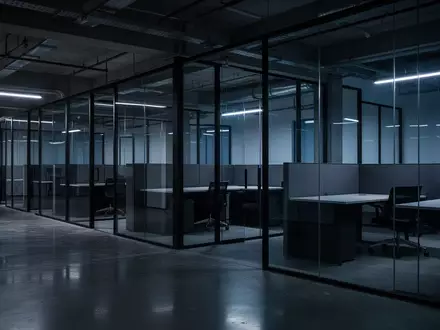 Ein nächtliches, unbesetztes Großraumbüro mit modernen Glaswänden und polierten Bodenflächen in einer sterilen Atmosphäre. - Foto: über boerse-global.de