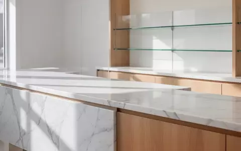 Ein minimalistisch gestalteter, heller Tresenbereich in einer modernen Apotheke ohne Personen oder technische Geräte. - Foto: über boerse-global.de