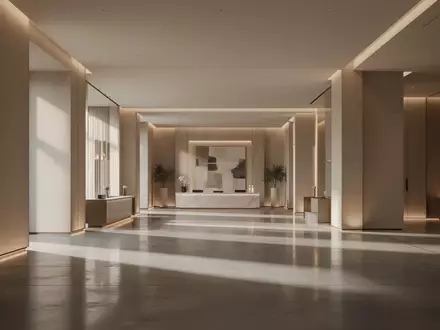 Modernes, minimalistisches Hotelfoyer mit polierten Betonböden und warmer Beleuchtung ohne sichtbare Personen oder Technik. - Foto: über boerse-global.de