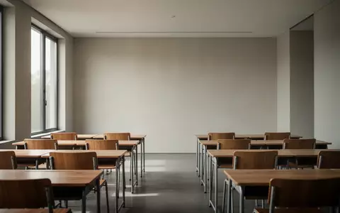 Ein leerer, minimalistisch gestalteter Klassenraum mit Holzmöbeln in natürlichem Tageslicht. - Foto: über boerse-global.de