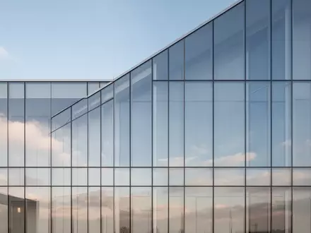 Moderne Glasfassade eines Bürogebäudes bei Tageslicht mit Spiegelung des Himmels - Foto: über boerse-global.de