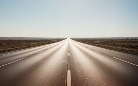 Eine leere, mehrspurige Autobahn bei klarem Wetter, die sich bis zum Horizont erstreckt. - Foto: über boerse-global.de