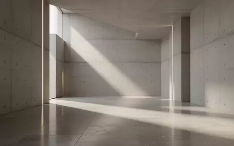 Ein minimalistischer, hochwertiger architektonischer Innenraum mit Betonwänden und polierten Steinböden bei natürlichem Lichteinfall. - Foto: über boerse-global.de