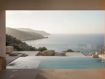 Eine sonnendurchflutete Hotelterrasse mit Blick auf eine ruhige Küstenlandschaft, minimalistische Architektur und natürliche Steinelemente. - Foto: über boerse-global.de