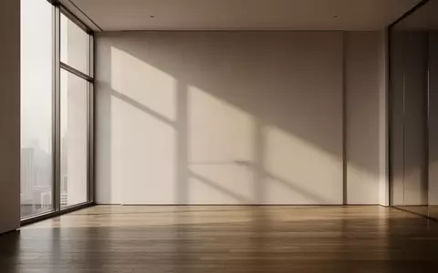 Ein minimalistischer, moderner Innenraum mit klaren Linien und weichem Tageslicht, das auf einen polierten Holzboden fällt. - Foto: über boerse-global.de