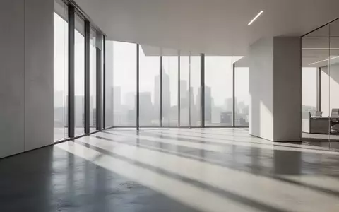 Ein minimalistisches, modernes Bürointerieur mit klaren Linien und natürlichem Lichteinfall auf einem polierten Betonboden. - Foto: über boerse-global.de