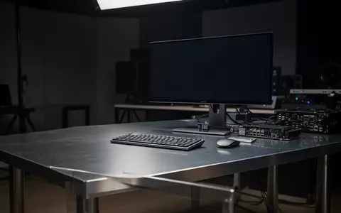 Ein moderner, minimalistischer Arbeitsplatz mit professioneller Ausrüstung in einem abgedunkelten Studio. - Foto: über boerse-global.de