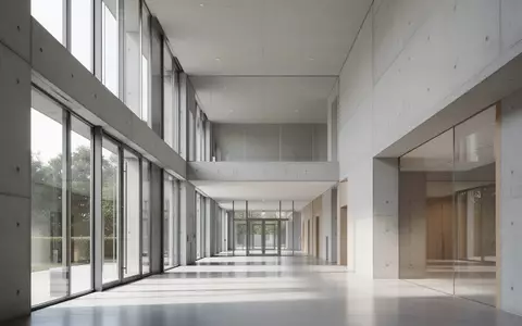 Ein minimalistischer, leerer Flur in einem modernen Verwaltungsgebäude mit klaren Linien und natürlichem Lichteinfall. - Foto: über boerse-global.de